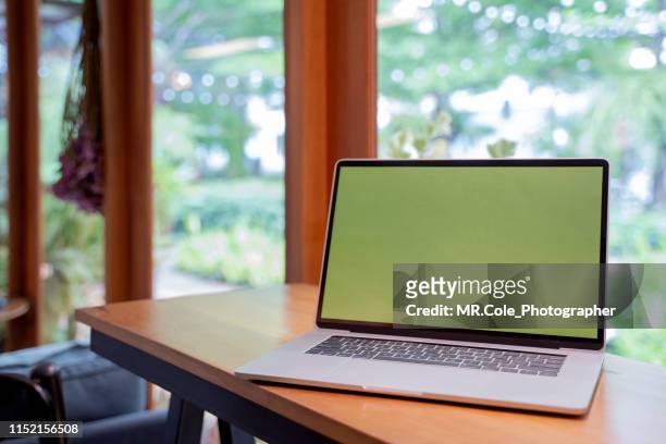 laptop mock up with green screen in coffee shop - chroma key stock pictures, royalty-free photos & images
