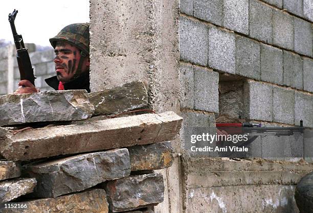 Kosovo Liberation Army soldiers monitor the roads near Suva Reka in Kosovo Thursday, February 25, 1999. Tensions are high in Kosovo after the peace...