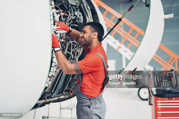 técnico trabajando en motor jet - vehículo aéreo fotografías e imágenes de stock