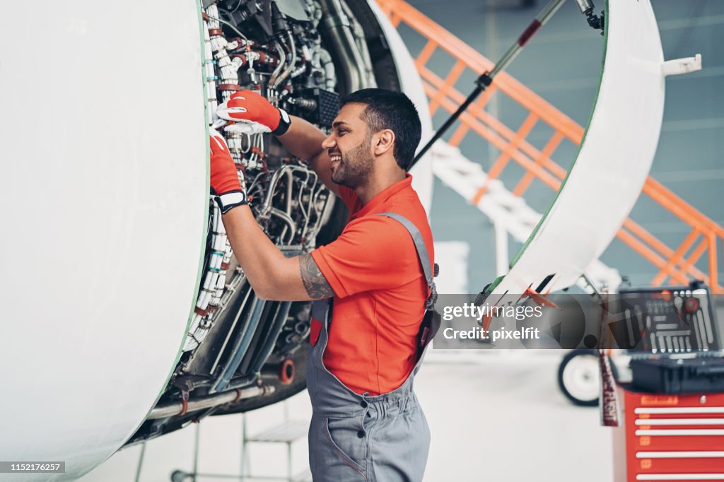 Technician working on jet engine