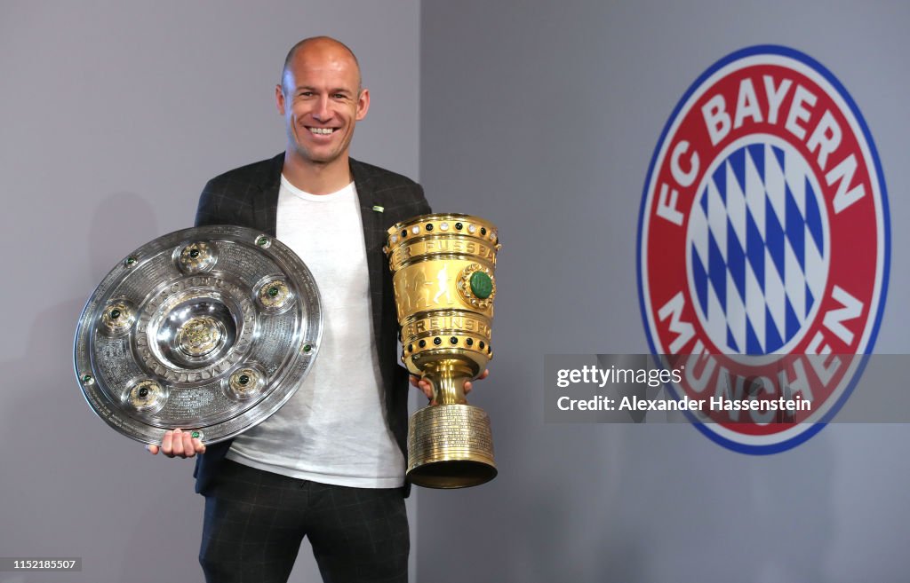 Arjen Robben And Franck Ribery Hand Over Championship And DFB Cup Trophy To FCB Erlebniswelt