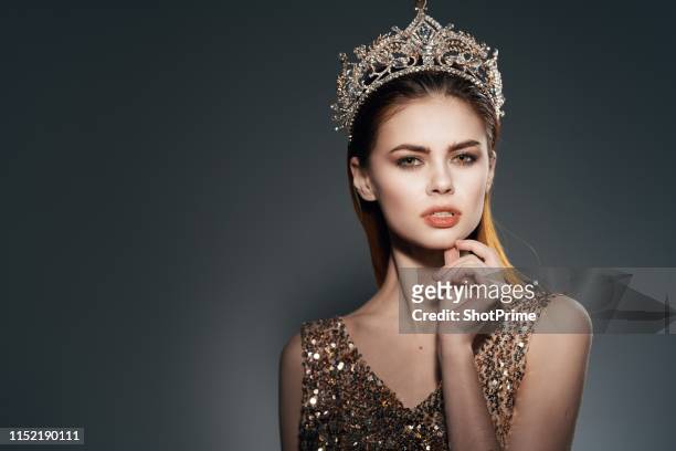 young woman in beautiful crown is looking at the camera - beauty pageant crown stock-fotos und bilder
