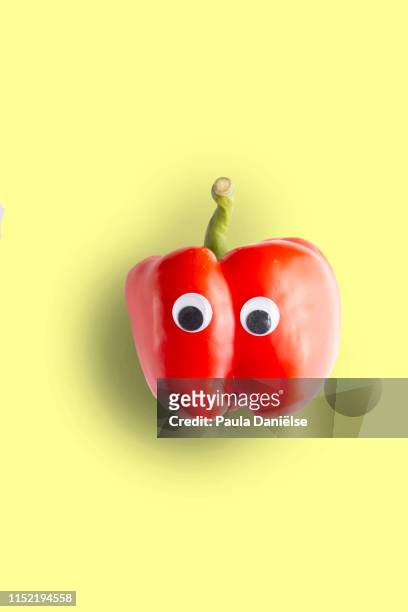 red bell pepper with googly eyes - anthropomorphic face stock pictures, royalty-free photos & images