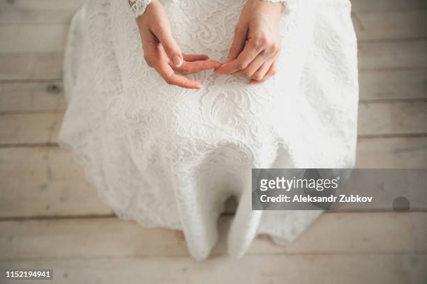 the bride in a white, openwork, wedding dress. the girl's hands closeup. copy space - eternal youth stock pictures, royalty-free photos & images