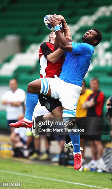 Phil Mackenzie of Canada tangles with Manoa Vosawai of Italy during the Churchill Cup between Italy A and Canada at Franklin's Gardens on June 4,...