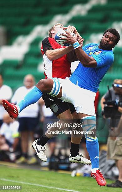 Phil Mackenzie of Canada tangles with Manoa Vosawai of Italy during the Churchill Cup between Italy A and Canada at Franklin's Gardens on June 4,...