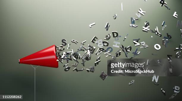 red megaphone and silver alphabet letters in front of gray wall - message stock-fotos und bilder