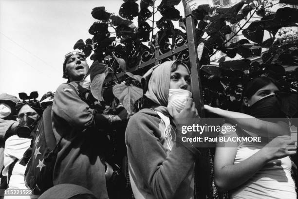 Students watch from the hill as demonstrators face the police during protests against the 27th Group of Eight Summit in July, 2001 in Genoa, Italy....