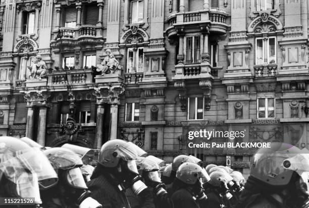 Police wearing gas masksand riot helmets gather in an area downtown during protests against the 27th Group of Eight Summit in July, 2001 in Genoa,...