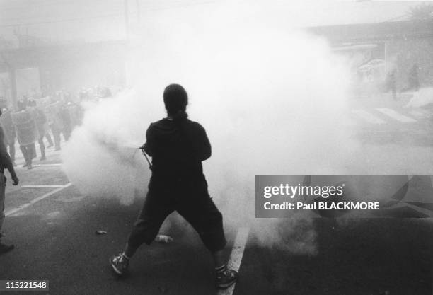 Protesters use smoke to obscure the view of the police during protests against the 27th Group of Eight Summit in July, 2001 in Genoa, Italy. Hundreds...
