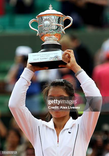 Na Li of China lifts the trophy following her victory during the women's singles final match between Francesca Schiavone of Italy and Na Li of China...