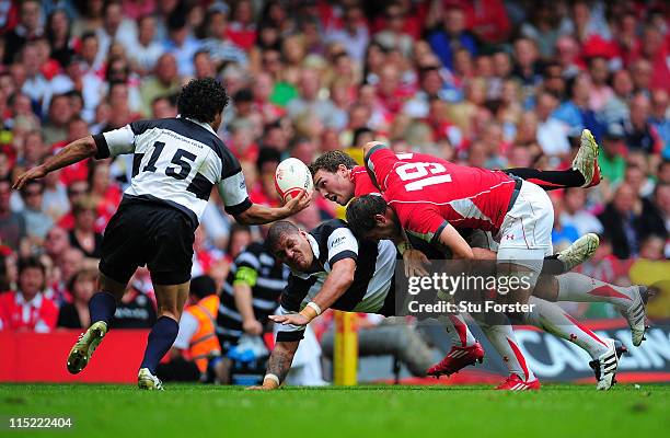 Barbarian replacement Willie Mason offloads to Isa Nacewa to score the last Barbarians try during the International match between Wales and...