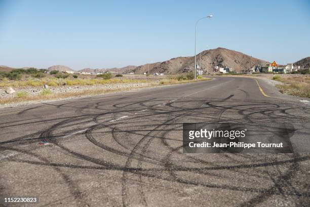 boredom burnout - circular skid marks on tarmac, sultanate of oman, arabian peninsula - sked stock pictures, royalty-free photos & images