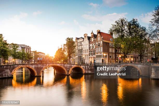 typical bridge on the canals in the central amsterdam - amsterdam bridge stock pictures, royalty-free photos & images
