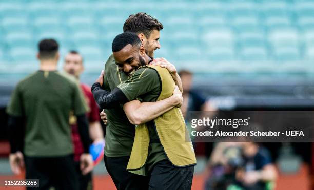 Alexandre Lacazette hugs Carl Jenkinson during Arsenal training session prior to the UEFA Europa League Final between Chelsea and Arsenal at Baku...