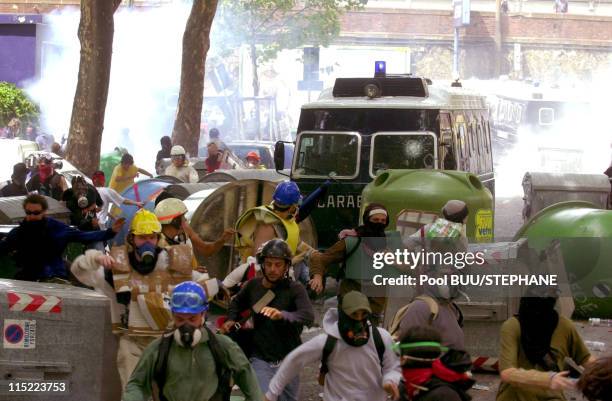 Protesters flee from police during protests against the 27th Group of Eight Summit on July 20, 2001 in Genoa, Italy. Hundreds of thousands of...