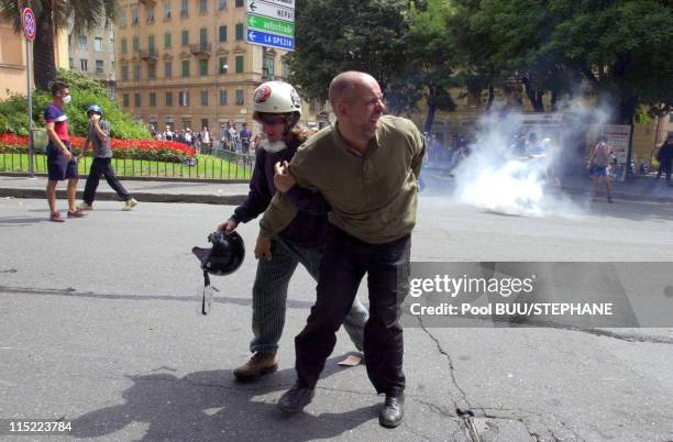 Protesters move away from tear gas during protests against the 27th Group of Eight Summit on July 20, 2001 in Genoa, Italy. Hundreds of thousands of...