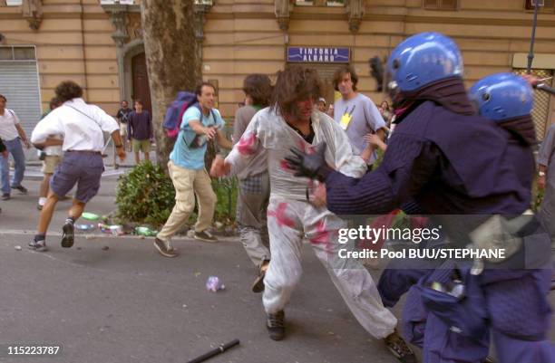 Members of Tutte Bianche clash with police during protests against the 27th Group of Eight Summit on July 20, 2001 in Genoa, Italy. Hundreds of...