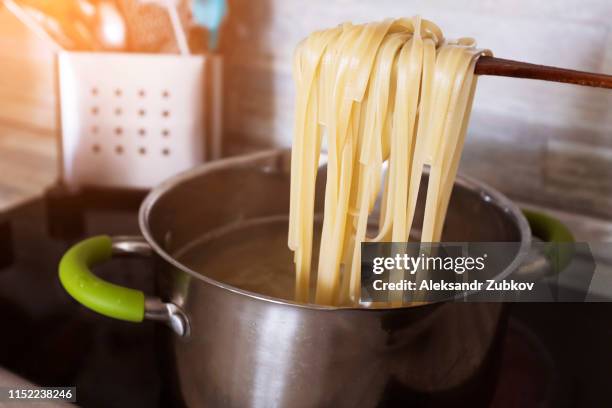 cooking pasta at home in a pan. spaghetti - boiling pasta stock pictures, royalty-free photos & images