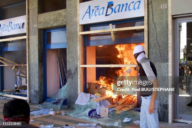 Demonstrators start a fire inside a bank during protests against the 27th Group of Eight Summit in July, 2001 in Genoa, Italy. Hundreds of thousands...