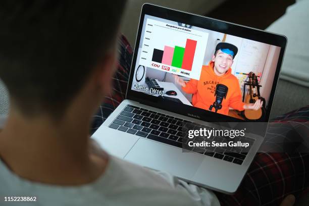 In this photo illustration a young man looks at a recent video by German YouTube star Rezo that heavily criticizes the German Christian Democrats...