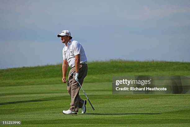 Graeme McDowell of Northern Ireland reacts to his approach to the 18th green during the third round of the Saab Wales Open on the Twenty Ten course...