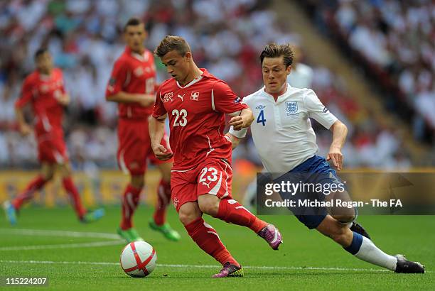 Scott Parker of England fights for the ball with Xherdan Shaqiri of Switzerland during the UEFA EURO 2012 Group G qualifying match between England...