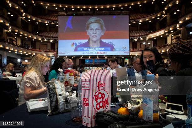 Box of popcorn sits next to reporters as they watch Democratic presidential candidate and U.S. Senator Elizabeth Warren on a monitor inside the spin...