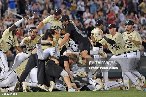 Players and coaches of the Vanderbilt Commodores celebrate after defeating the Michigan Wolverines to win the National Championship at the College...