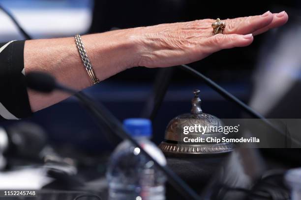 Scripps National Spelling Bee Head Judge Mary Brooks rings a bell after a competitor misspelled a word during the second round at the Gaylord...
