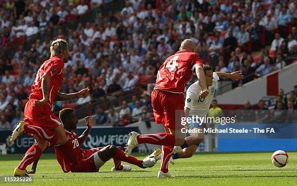 Johan Djourou of Switzerland brings down Jack Wilshere of England to give them a penalty during the UEFA EURO 2012 Group G qualifying match between...