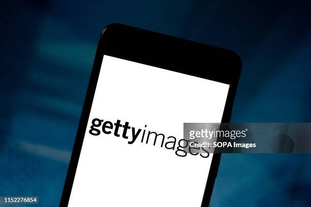In this photo illustration a Getty Images logo seen displayed on a smartphone.