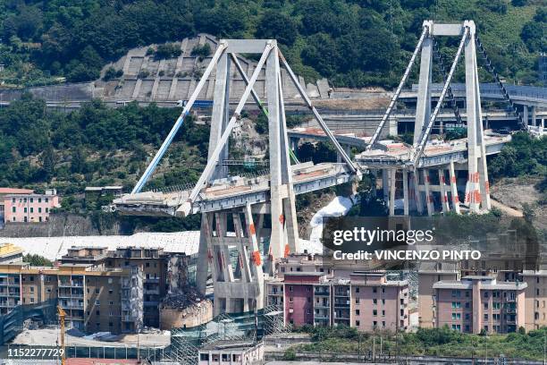 General view shows the two pylons of Genoa's Morandi motorway bridge that are to be destroyed with explosives, seen in red on the structure below, on...