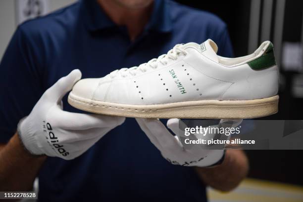 June 2019, Bavaria, Herzogenaurach: The archivist of the sporting goods manufacturer "adidas", Martin Gebhardt, shows one of the rare Stan...