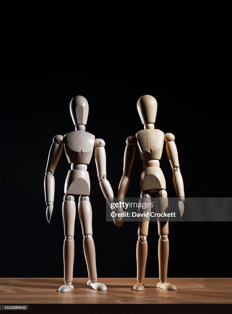 Artists figures holding hands