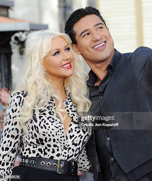 Recording Artist Christina Aguilera and Extra host Mario Lopez pose at Christina Aguilera visits EXTRA at The Grove on June 3, 2011 in Los Angeles,...