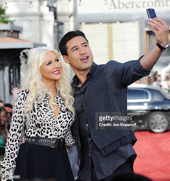 Recording Artist Christina Aguilera and Extra host Mario Lopez pose at Christina Aguilera visits EXTRA at The Grove on June 3, 2011 in Los Angeles,...