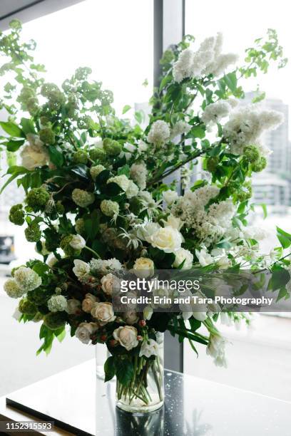 beautiful large flower arrangement at a wedding reception - big wedding reception stock pictures, royalty-free photos & images