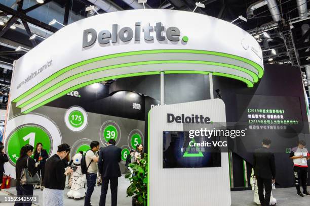 People visit the Deloitte stand on the opening day of the 2019 China International Fair for Trade in Services at China National Convention Center on...
