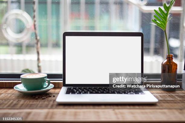 laptop on the table with coffee shop background. save path. - laptop on desk mockup stock pictures, royalty-free photos & images