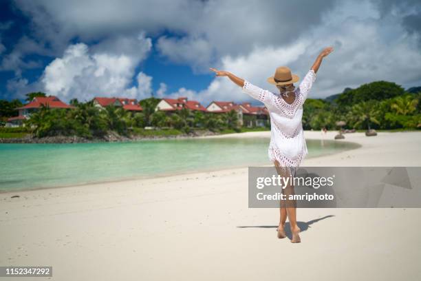 beautiful elegant sporty rich woman enjoying her time on tropical beach - private island stock pictures, royalty-free photos & images