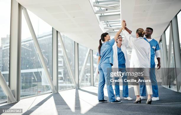 we did a great job! - doctor arms raised stock pictures, royalty-free photos & images