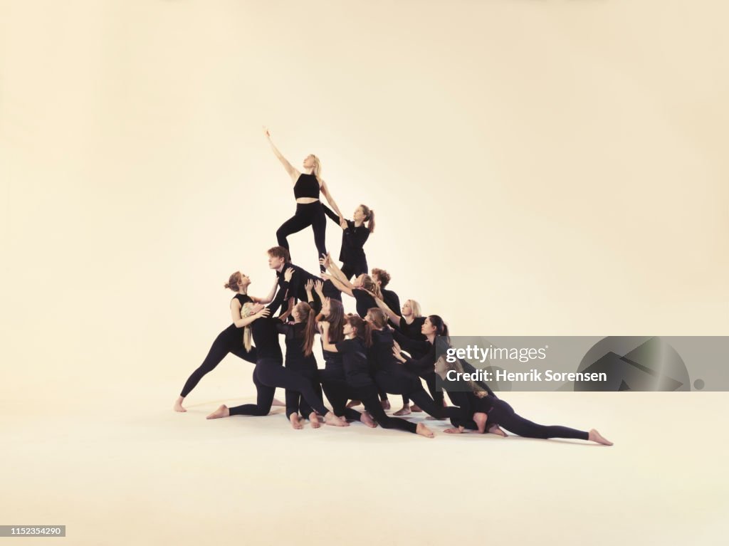 Group of young people forming a pyramid