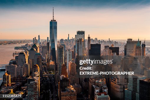 The majesty of Manhattan island taken from a helicopter above the downtown area at a golden hour The majesty of Manhattan island taken from a helicopter above the downtown area at a golden hour