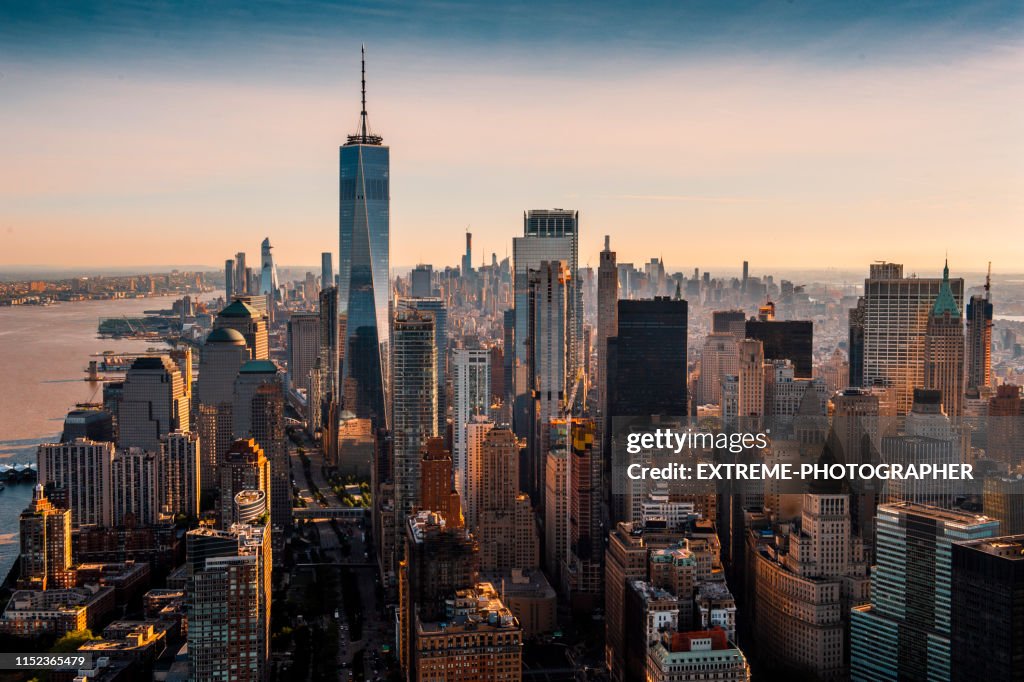 The majesty of Manhattan island taken from a helicopter above the downtown area at a golden hour