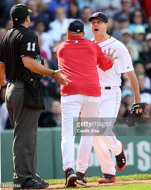 Jonathan Papelbon of the Boston Red Sox and home plate umpire Tony Randazzo are separated by manager Terry Francona of the Red Sox in the bottom of...