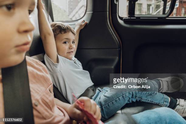 brothers inside a new york taxi - taxi boys stock pictures, royalty-free photos & images