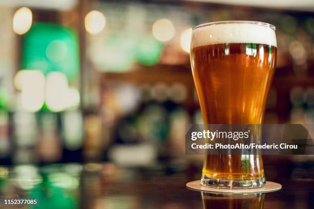 beer glass on table - empty beer glass stock pictures, royalty-free photos & images