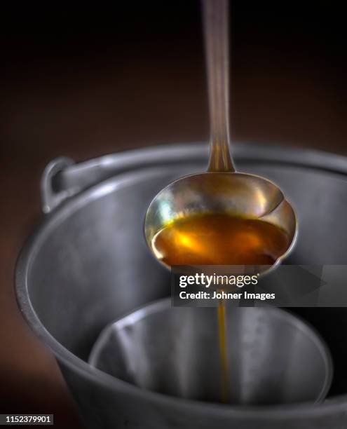 ladle with liquid - mestolo foto e immagini stock
