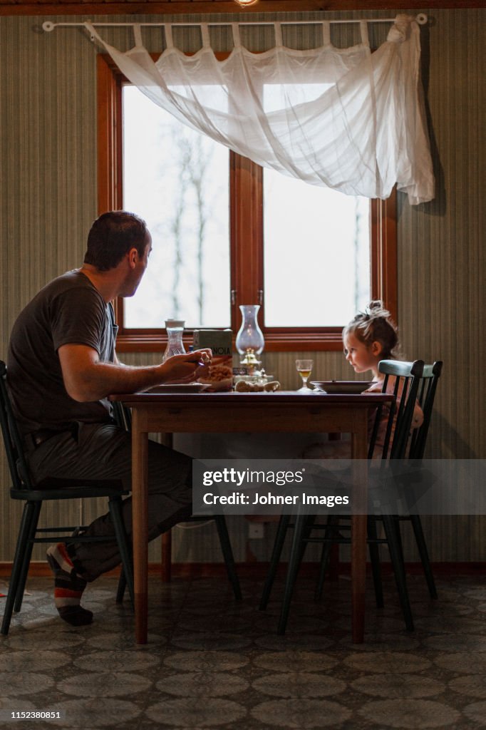 Father and daughter having meal